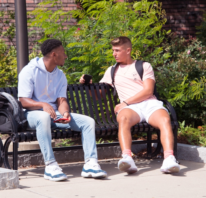 Two students sitting on a bench