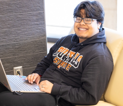 Smiling student with a laptop