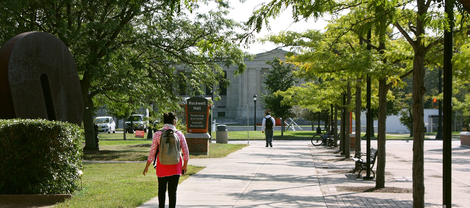 Student walking on campus near Rockwell