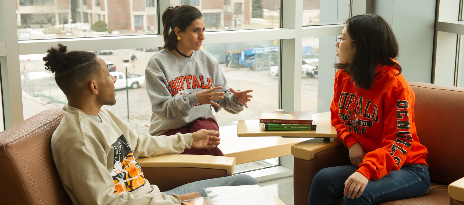 Students sitting in chairs, talking