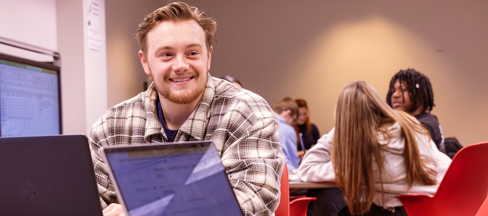 Student in business class with laptop