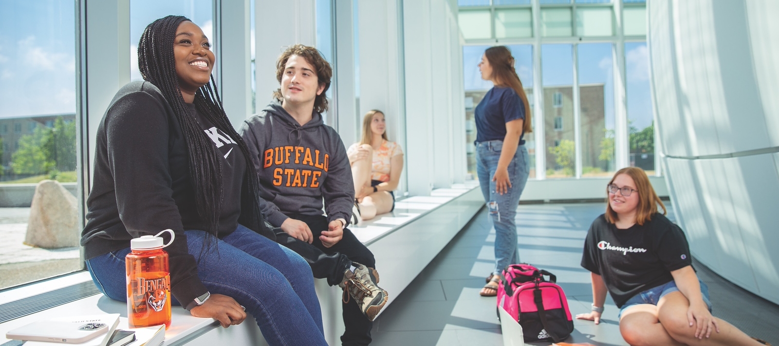Students sitting in the Science and Mathematics Complex hallway