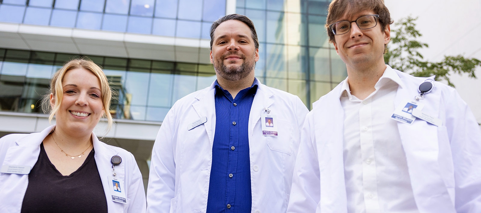 Three students in lab coats